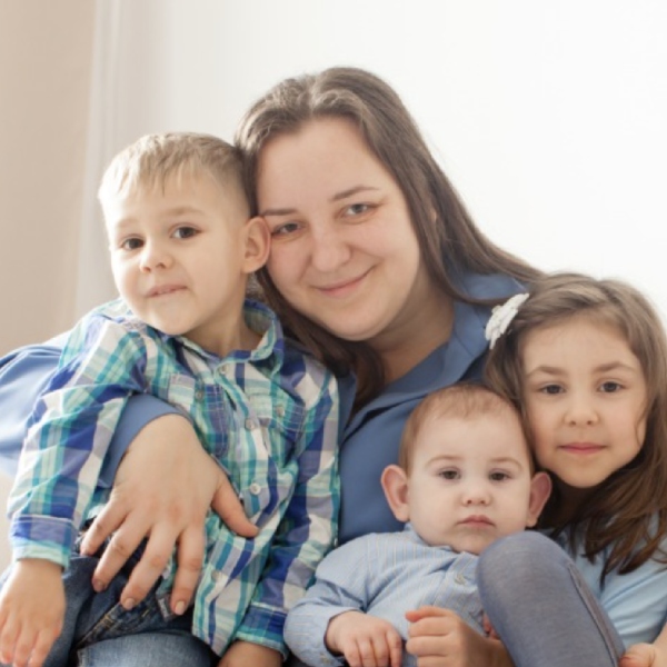 Mother hugging her three children