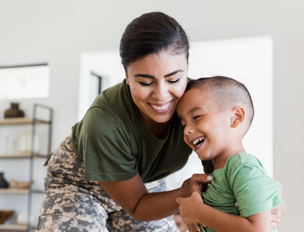 Veteran smiling with child