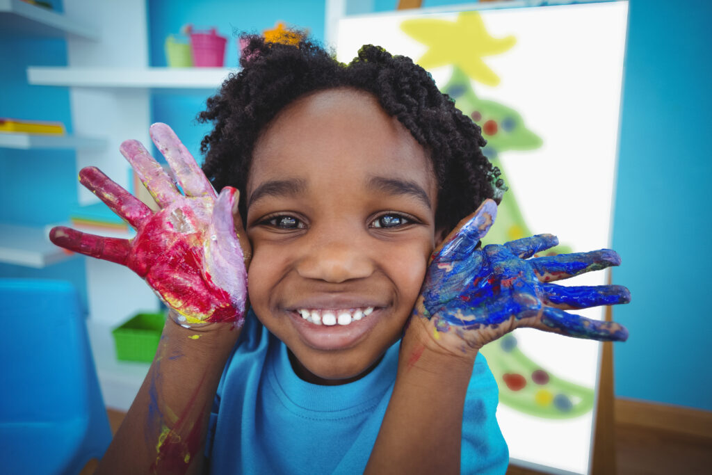 Young child with paint on hands