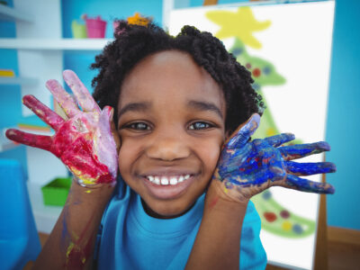 Young child with paint on hands