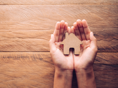 Hands holding a house cutout