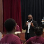 Mayor Brown speaking on a microphone to children