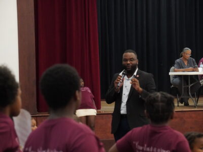 Mayor Brown speaking on a microphone to children